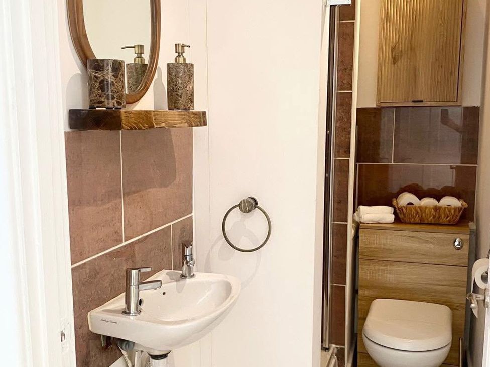 A bathroom with a sink and toilet at Central Tenby 3 Bed Apt Sleeps 6 to 8 Dog Friendly in Tenby
