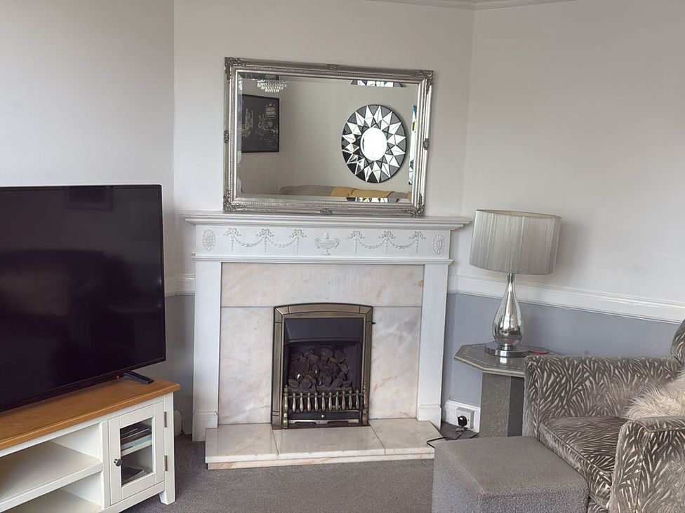 A living room with a television and fireplace at 5 Bed Villa Sleeps 10 Pets Garden Parking Skegness