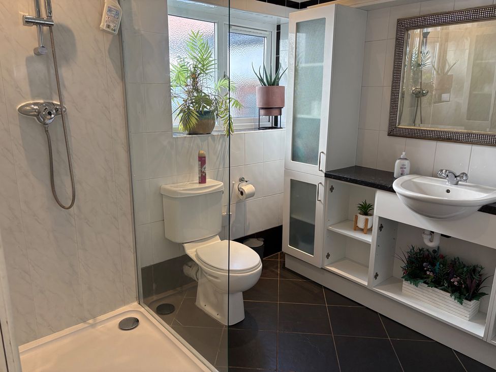A bathroom with a shower and toilet at 5 Bed Villa Sleeps 10 Pets Garden Parking Skegness