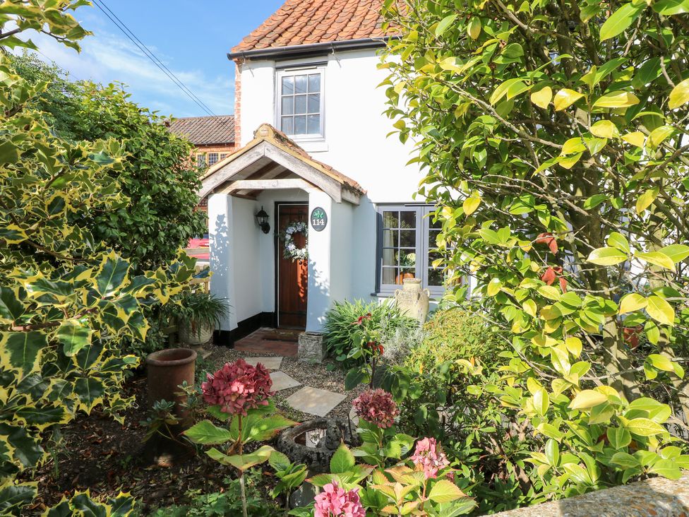 A front garden leading to the entrance at Hollyhedge Cottage in Briston