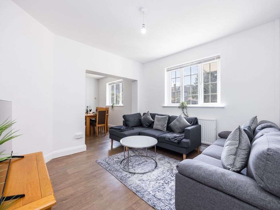 A living room with a sofa and coffee table at House Sleeps 14 with Parking and Garden in East Tilbury