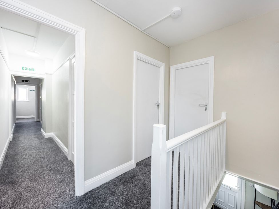 A hallway with doors and rail at House Sleeps 14 with Parking and Garden East Tilbury