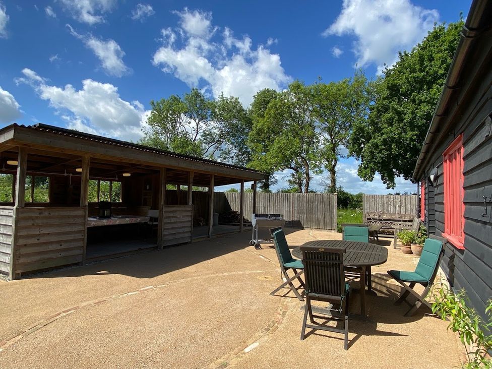 An outdoor area with seating and a barbecue at Pet Friendly 3Bed Barn Sleeps 7 Parking Garden in Westhall near Halesworth