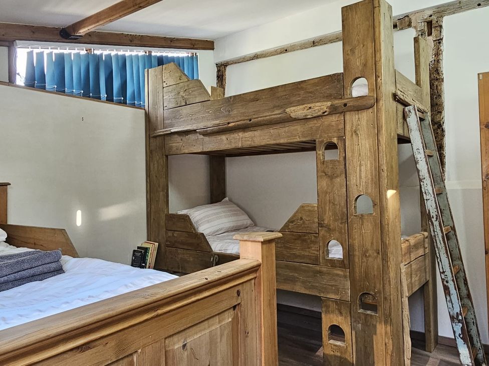 A bedroom with a bunk bed and a single bed at Pet Friendly 3Bed Barn Sleeps 7 Parking Garden Westhall near Halesworth