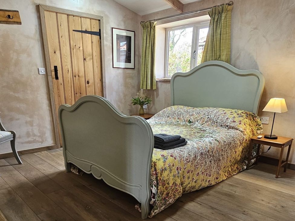 A bedroom with a bed and bedside table at Pet Friendly 3Bed Barn Sleeps 7 Parking Garden Westhall near Halesworth