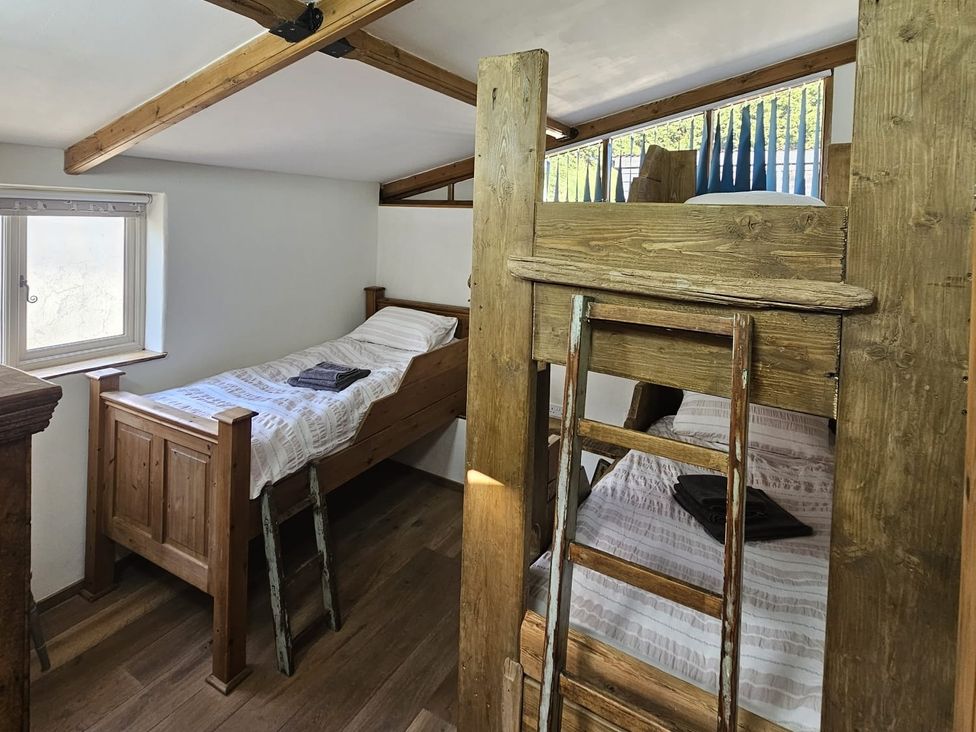A bedroom with bunk beds and a window at Pet Friendly 3Bed Barn Sleeps 7 Parking Garden Westhall near Halesworth