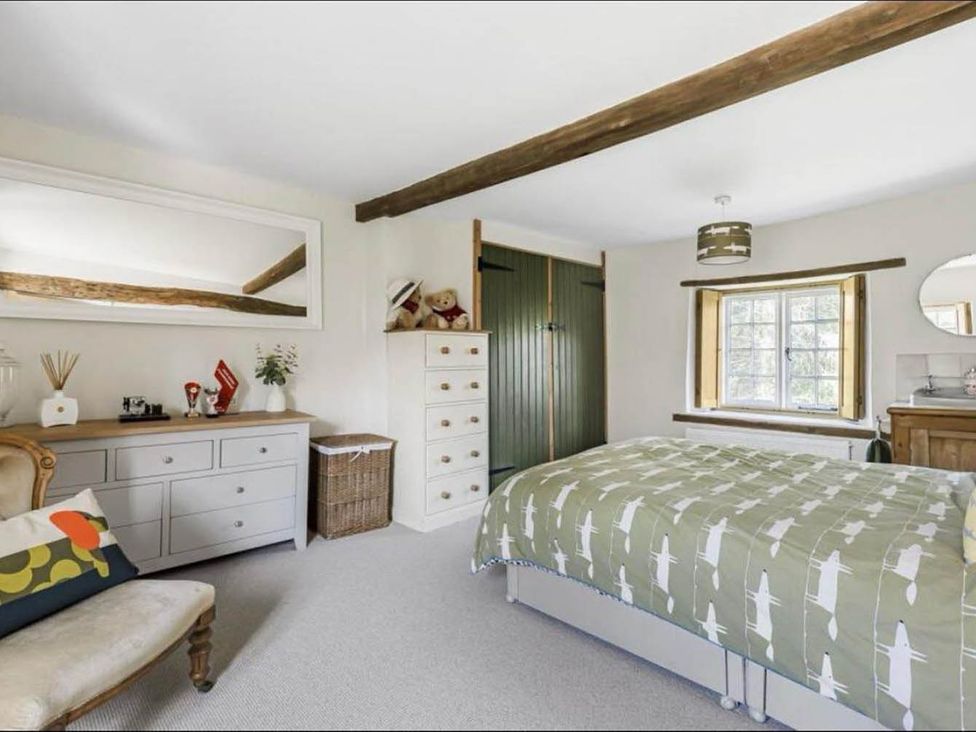 A bedroom with a bed and dresser at 17th Century Farmhouse Near Silverstone Circuit, Tiffield