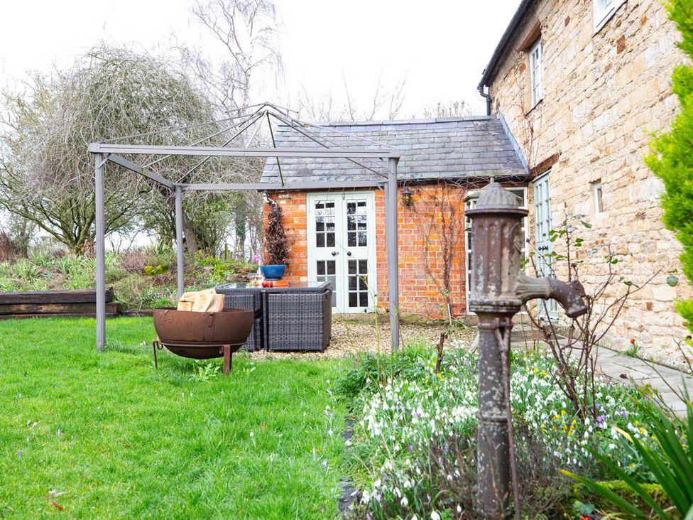 An outdoor garden with a gazebo and seating area at 17th Century Farmhouse Near Silverstone Circuit, Tiffield
