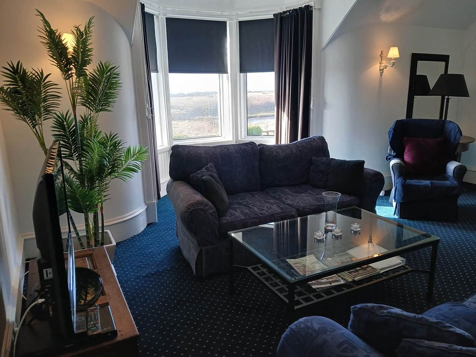 A living room with a sofa, coffee table and television at Sleeps6 3Bed Ayrshire Coast Near Beach, Prestwick