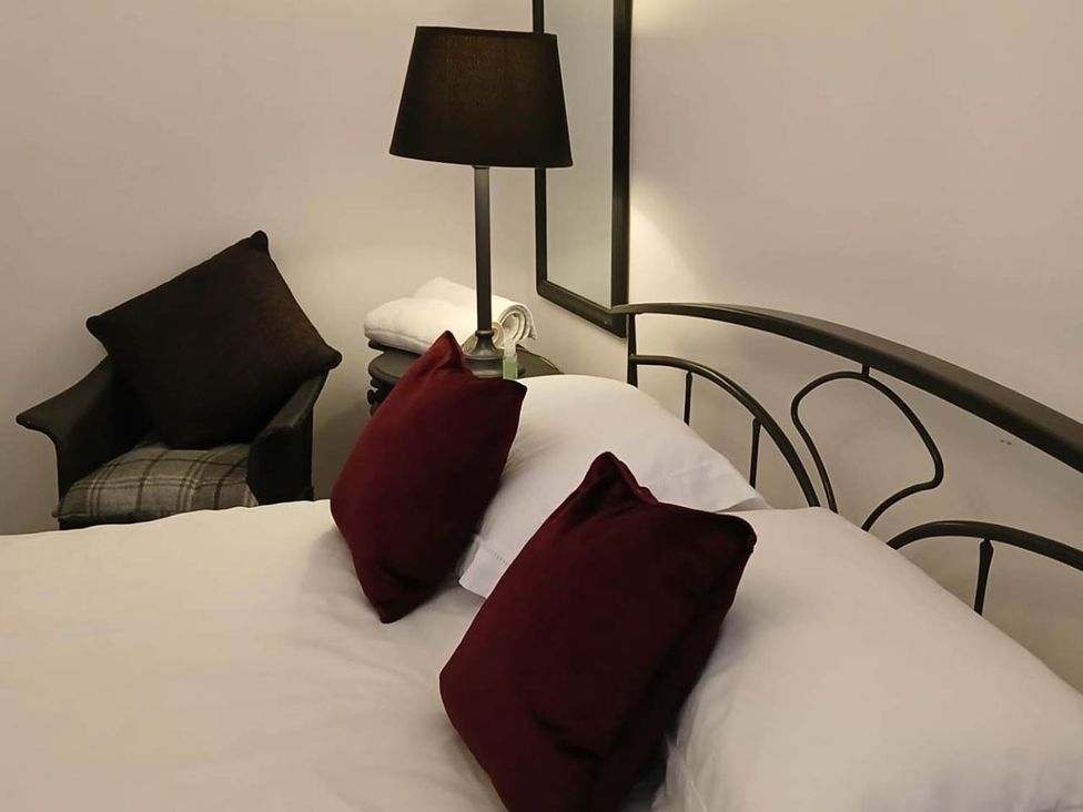 A bedroom with a bed and lamp at Sleeps6 3Bed Ayrshire Coast Near Beach, Prestwick
