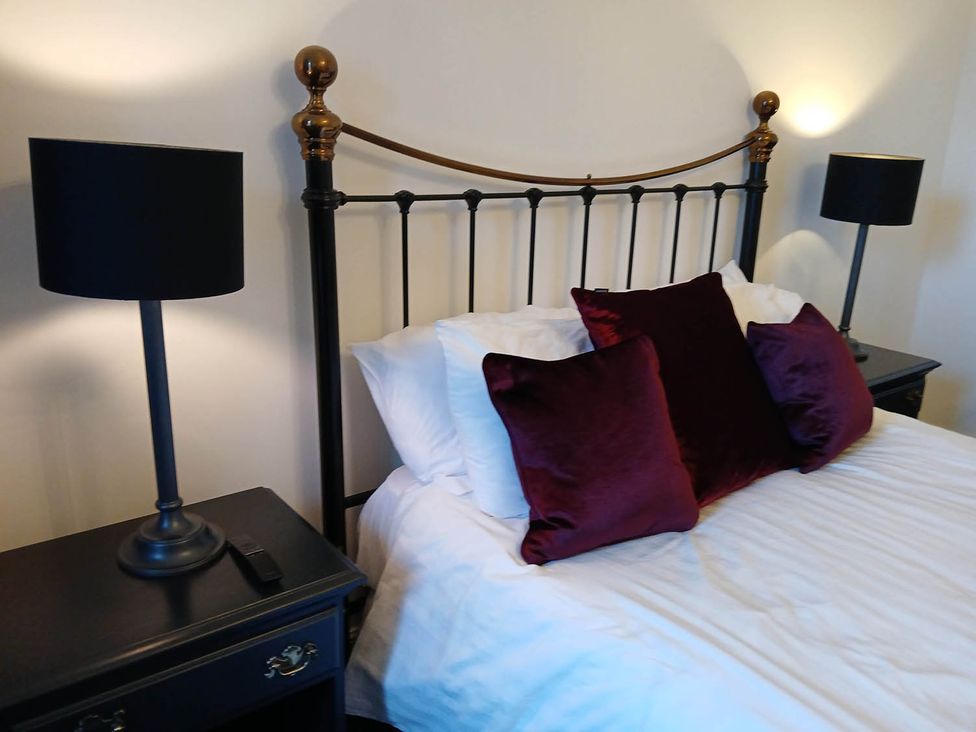 A bed with pillows and lamps in the bedroom at Sleeps6 3Bed Ayrshire Coast Near Beach in Prestwick