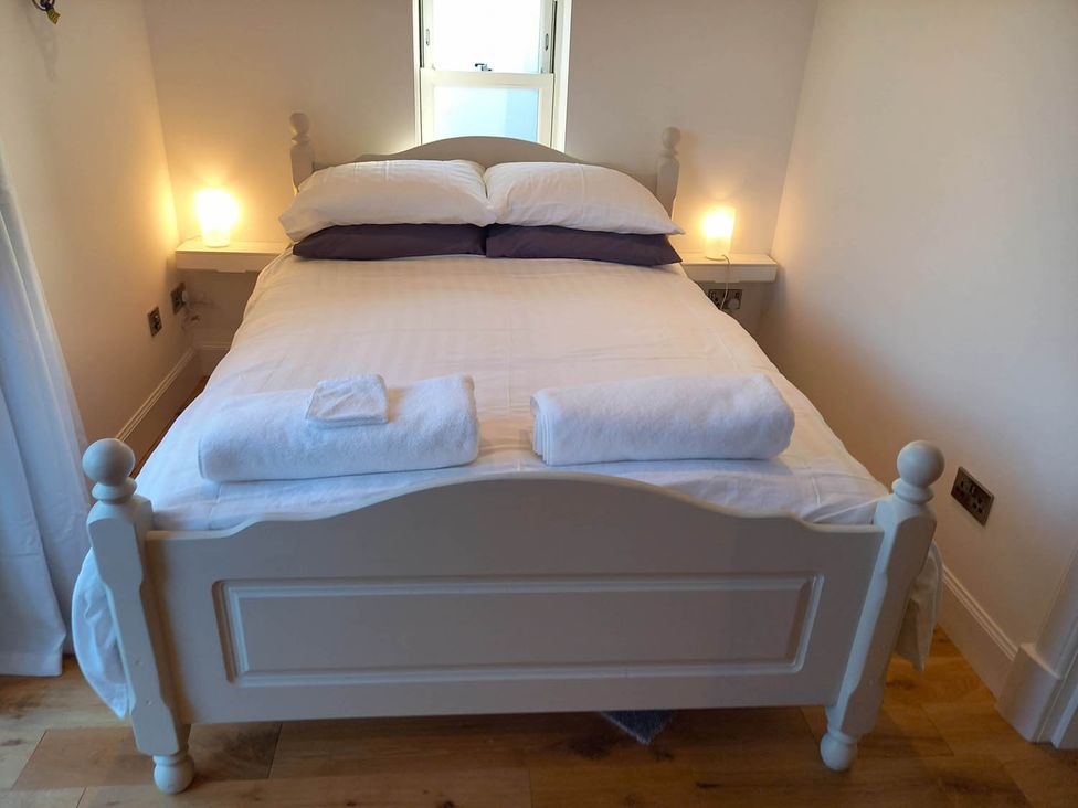 A bedroom with a bed and bedside table at Sleeps6 3Bed Ayrshire Coast Near Beach Prestwick
