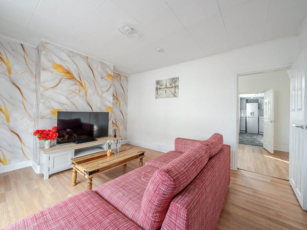A living room with a sofa and television in Cosy Hartlepool Home Sleeps 5 Pet Friendly WiFi Hartlepool