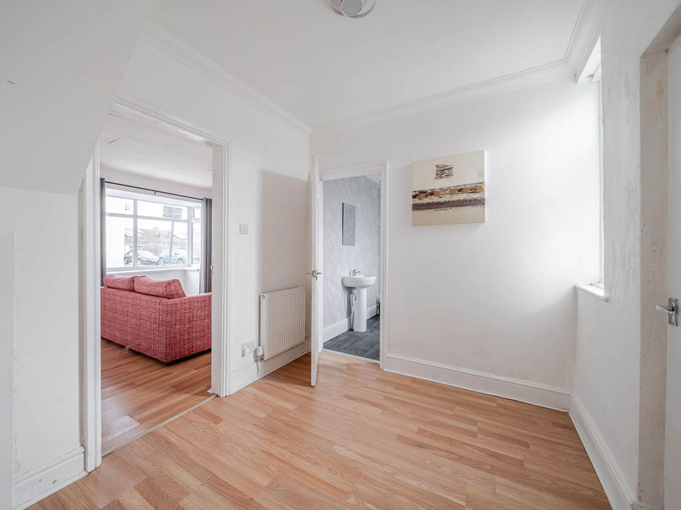 A hallway with doors leading to a bathroom and living room at Cosy Hartlepool Home Sleeps 5 Pet Friendly WiFi in Hartlepool