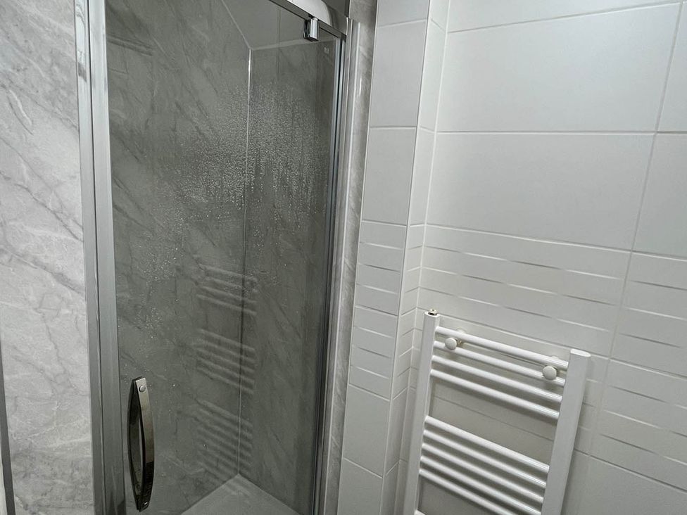 A bathroom with a shower and towel warmer at 1bed apartment nr beach with garden, Margate