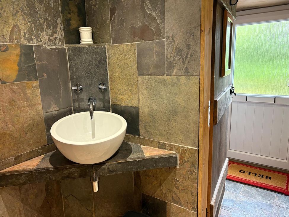 A bathroom with a sink and tap at Cosy Cottage Retreat in Edinbane