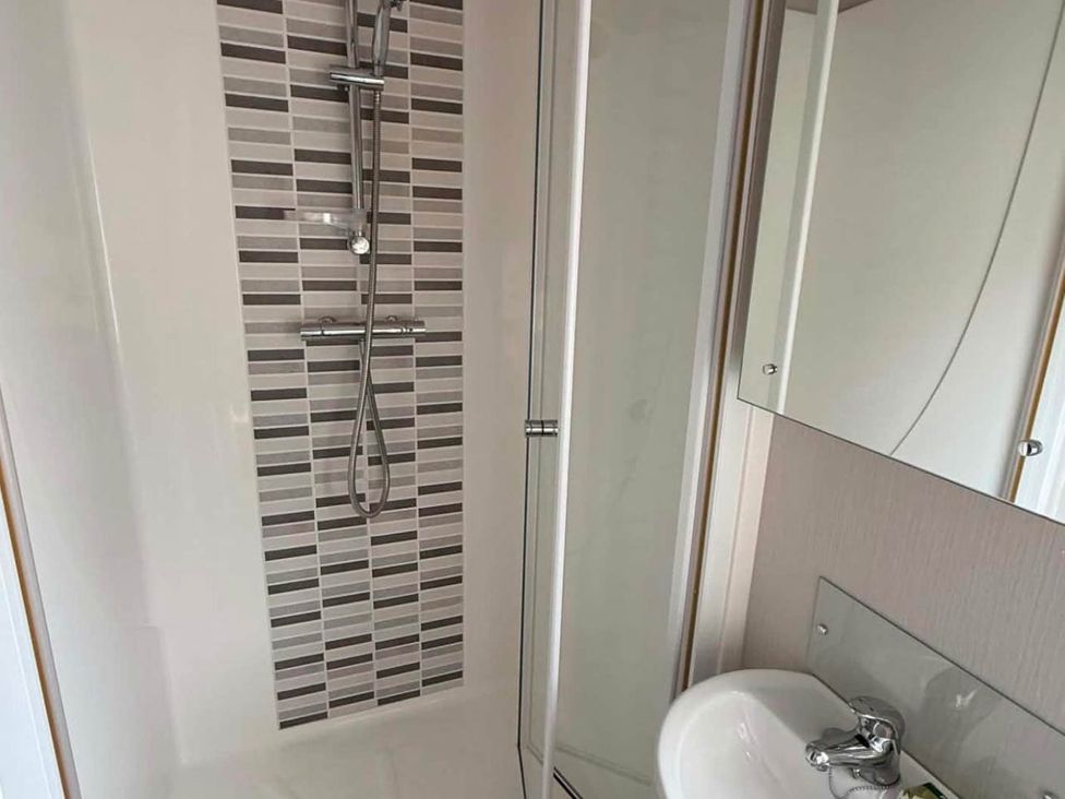 A bathroom with a shower and sink at 3 Bed Lodge Sleeps 6 Decking Parking WiFi Dunbar