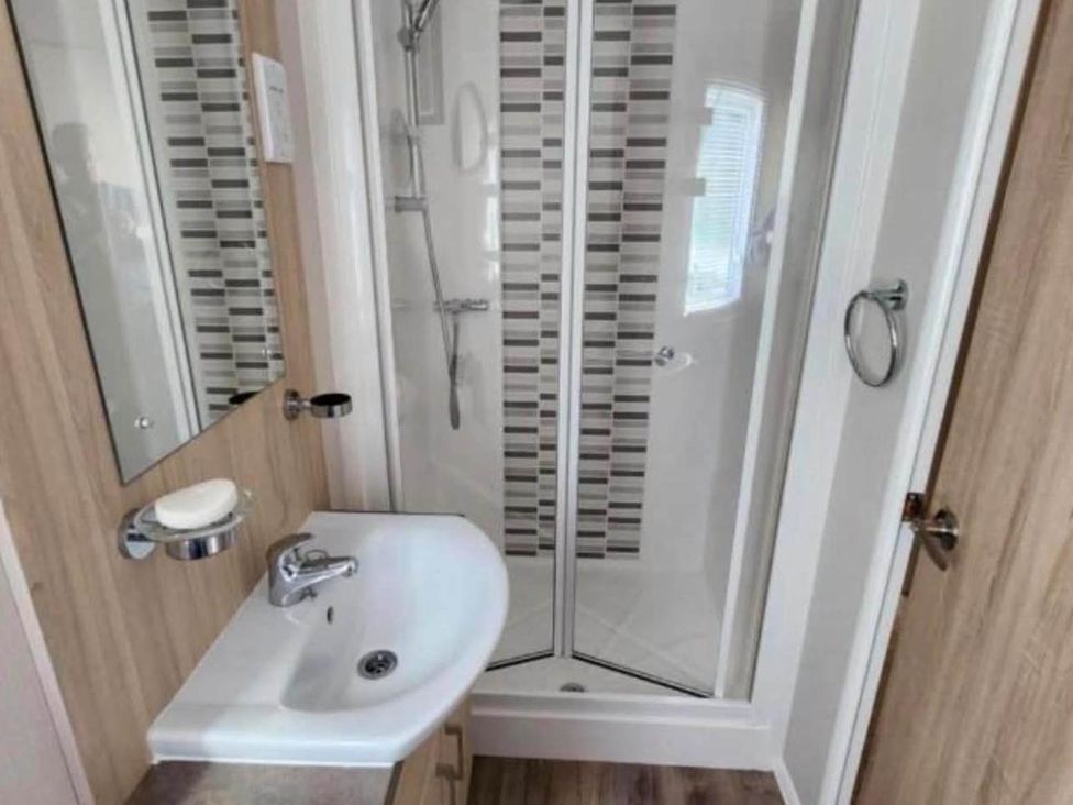 A bathroom with a shower and sink at 3 Bed Lodge Sleeps 6 Decking Parking WiFi Dunbar