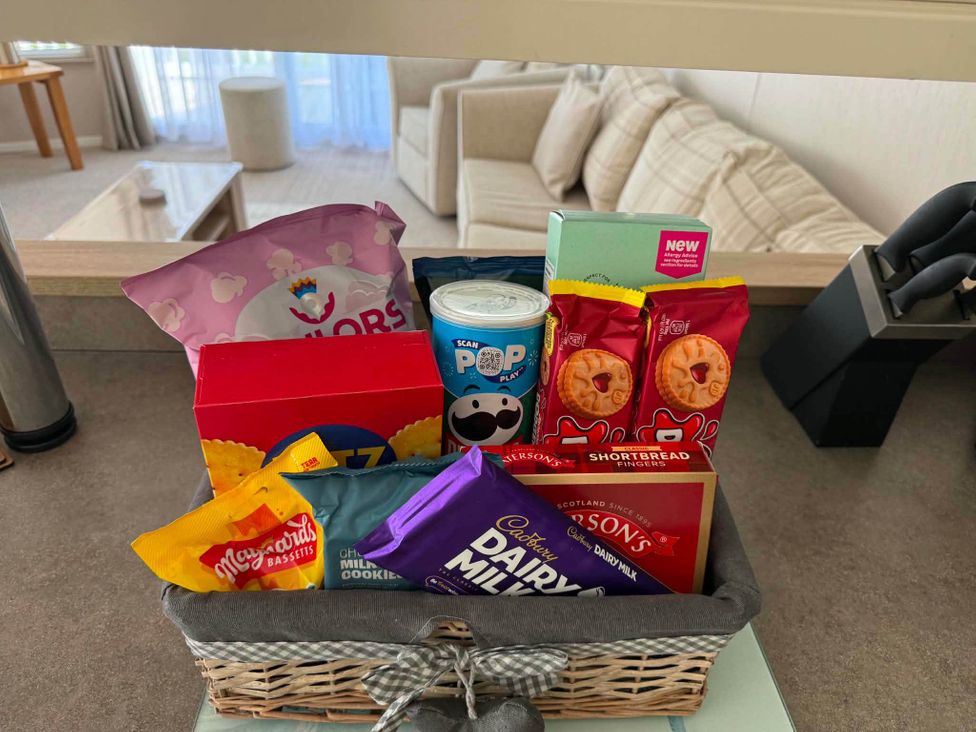 A basket with snacks including popcorn and chocolate at 3 Bed Lodge Sleeps 6 Decking Parking WiFi, Dunbar