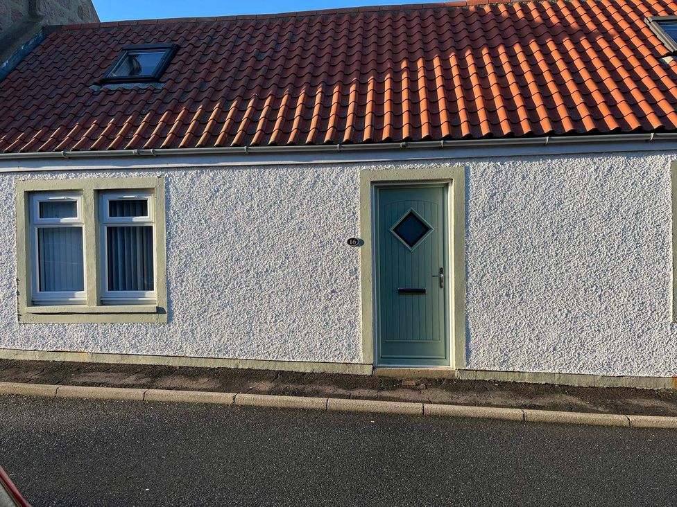 An exterior view of a house with a green door and a window at Costal Cottage Boddam Sleeps6 Pet Friendly, Boddam