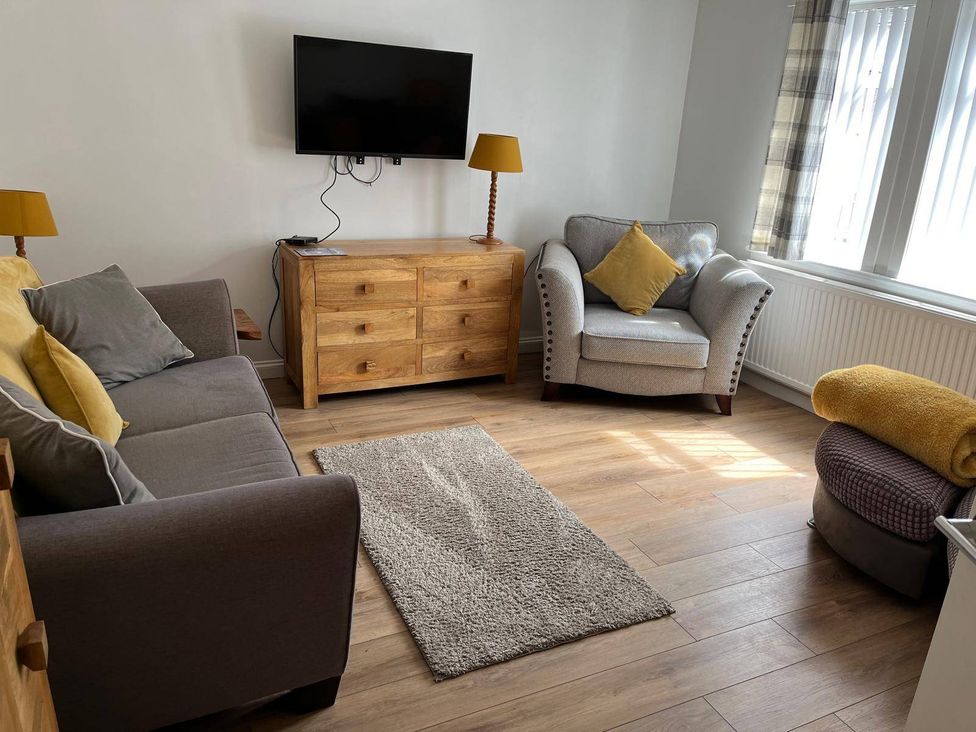 A living room with a sofa and armchair at Costal Cottage Boddam Sleeps6 Pet Friendly in Boddam