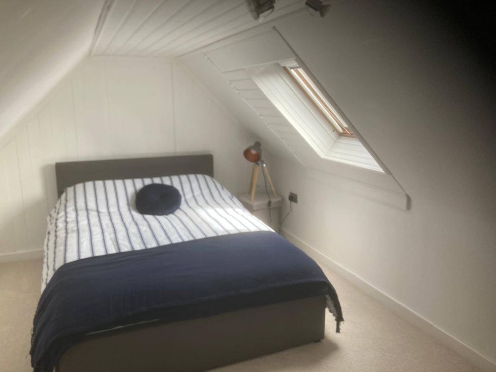 A bedroom with a bed and lamp at Costal Cottage Boddam Sleeps6 Pet Friendly in Boddam