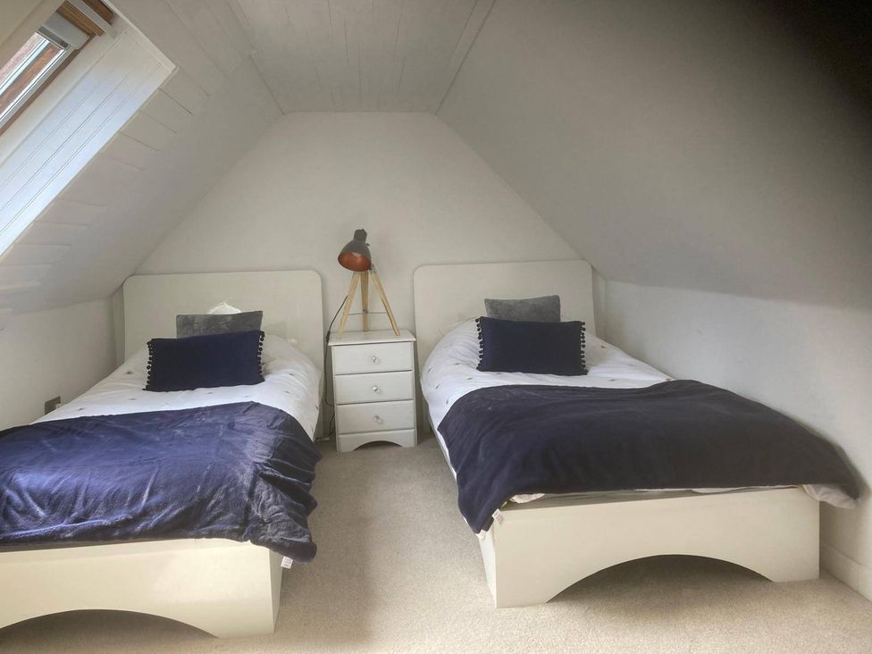 A bedroom with two single beds and a lamp at Costal Cottage Boddam Sleeps6 Pet Friendly in Boddam