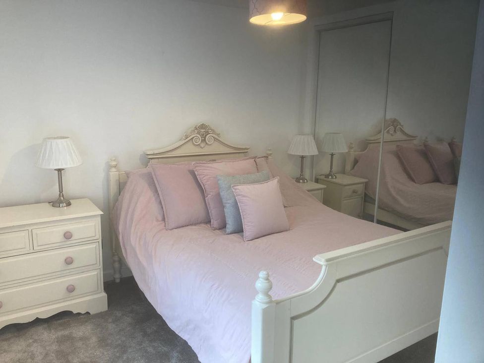 A bedroom with a bed and nightstand at Costal Cottage Boddam Sleeps6 Pet Friendly in Boddam