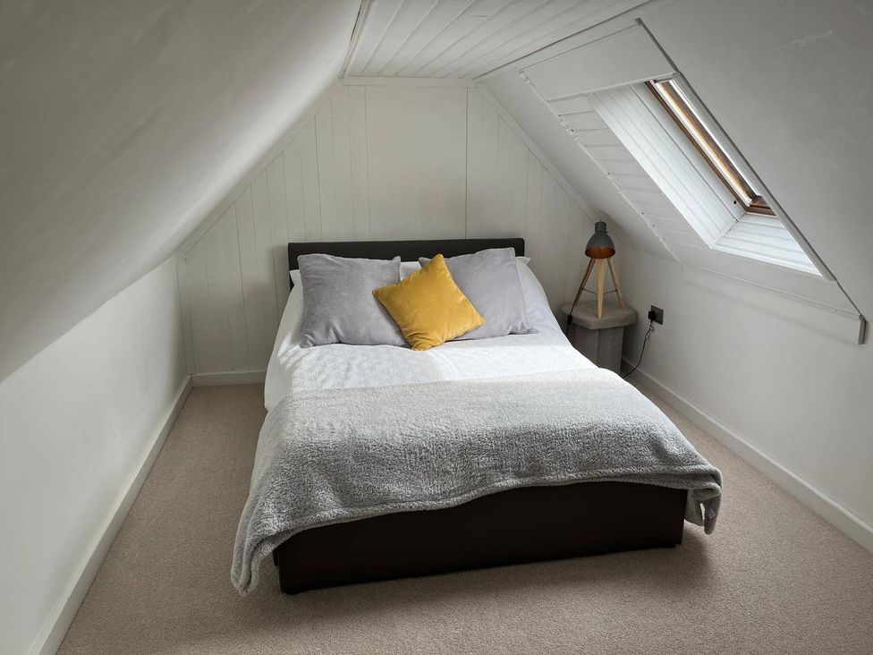 A bedroom with a bed and a lamp at Costal Cottage Boddam Sleeps6 Pet Friendly in Boddam