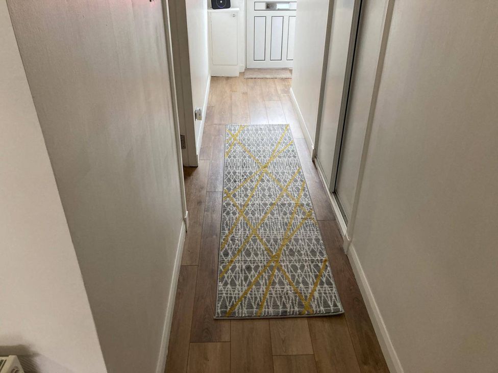 A hallway with a rug and a door at Costal Cottage Boddam Sleeps6 Pet Friendly Boddam