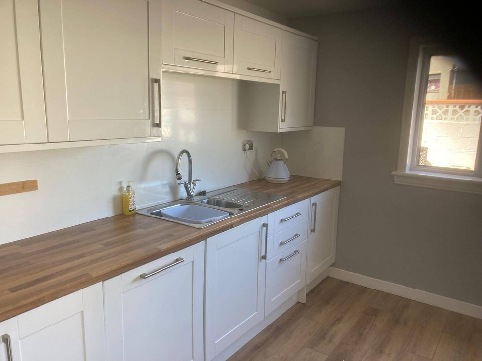 A kitchen with cabinets, sink, and kettle at Costal Cottage Boddam Sleeps6 Pet Friendly in Boddam
