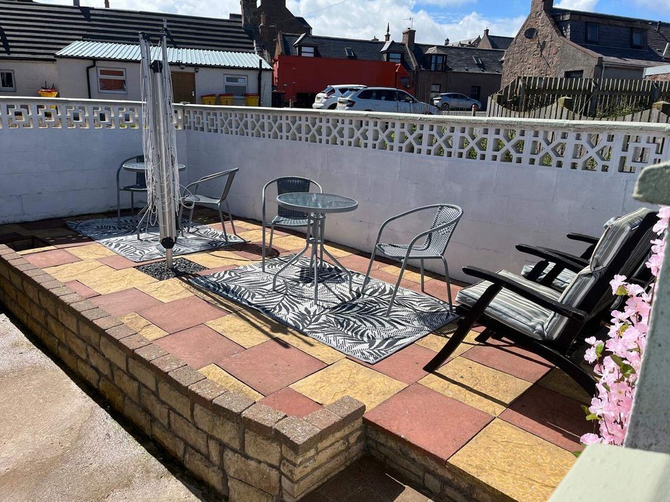 An outdoor seating area with table and chairs at Costal Cottage Boddam Sleeps6 Pet Friendly, Boddam