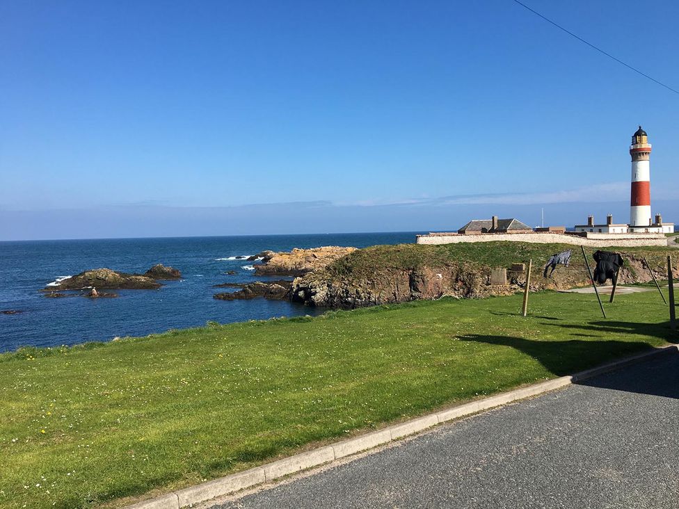 A coastal view with a lighthouse and ocean at Costal Cottage Boddam Sleeps6 Pet Friendly in Boddam