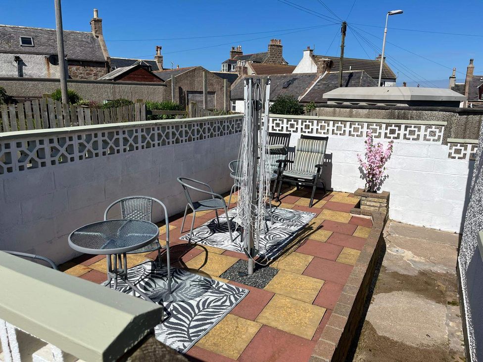An outdoor patio with seating and a clothes drying rack at Costal Cottage Boddam Sleeps6 Pet Friendly, Boddam