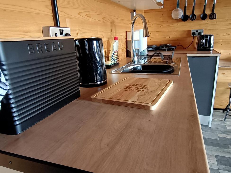 A kitchen countertop with a bread bin and kettle at Fairvine Cabin Fort Augustus Mtn View Pet Friendly, Fort Augustus