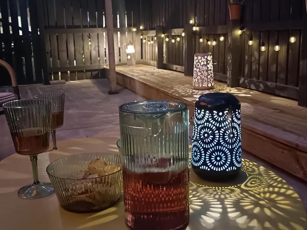 An outdoor setting with drinks and a lantern at Fairvine Cabin Fort Augustus Mtn View Pet Friendly Fort Augustus