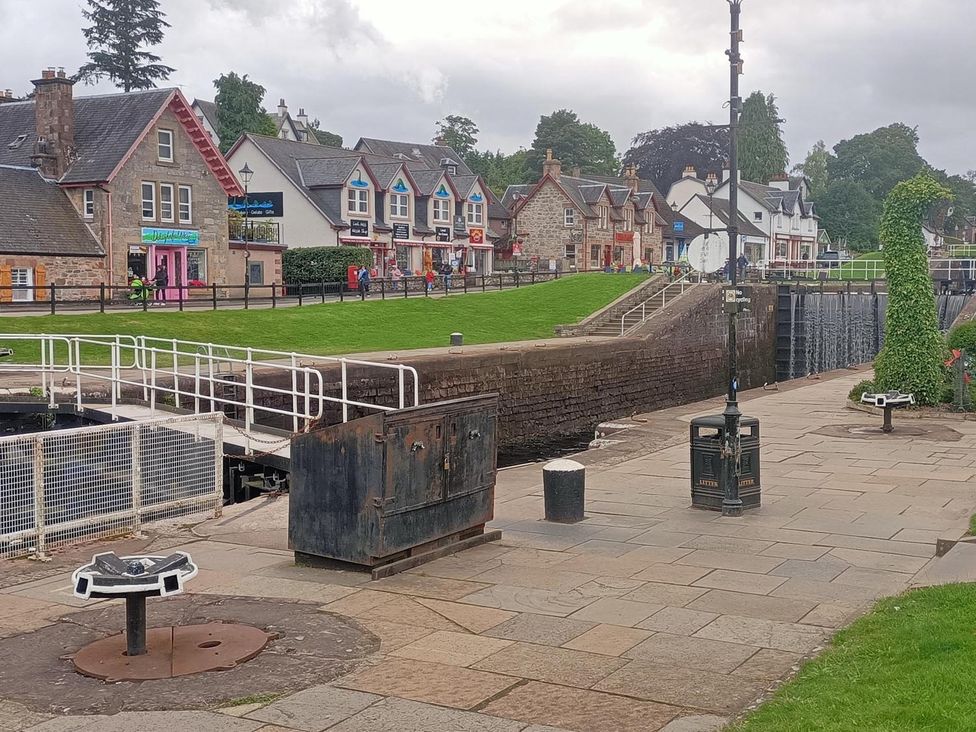 An outdoor area with buildings and a lock gate at Fairvine Cabin Fort Augustus Mtn View Pet Friendly in Fort Augustus