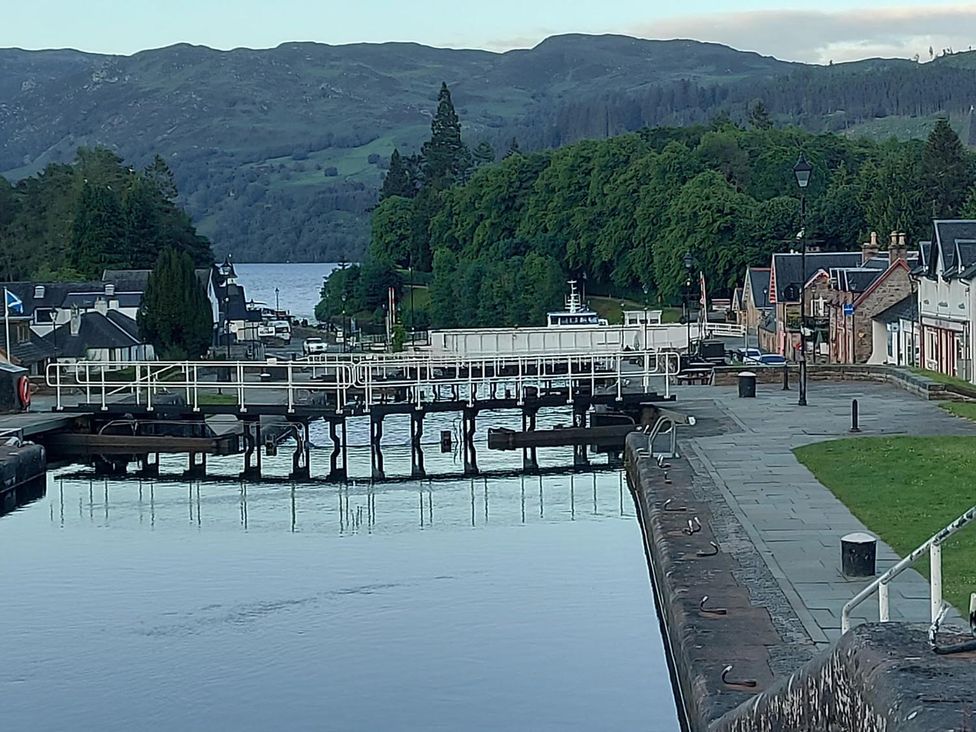 A view of a waterway with lock gates and boats at Fairvine Cabin Fort Augustus Mtn View Pet Friendly in Fort Augustus