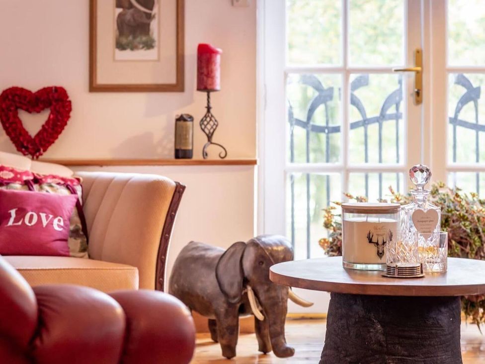 A living room with a table and elephant statue at Luxury Duplex Sleeps 2 Hot Tub Balcony Parking in Duncrievie near Milnathort