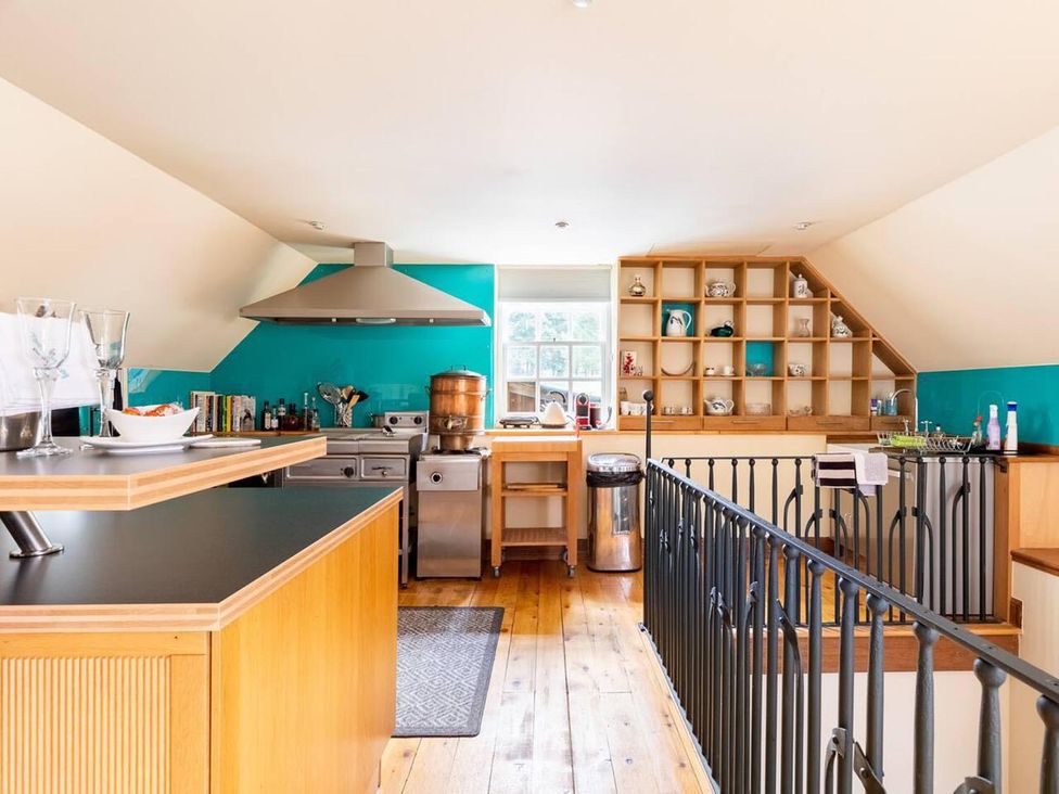 A kitchen with a stove, sink, and shelves at Luxury Duplex Sleeps 2 Hot Tub Balcony Parking Duncrievie near Milnathort