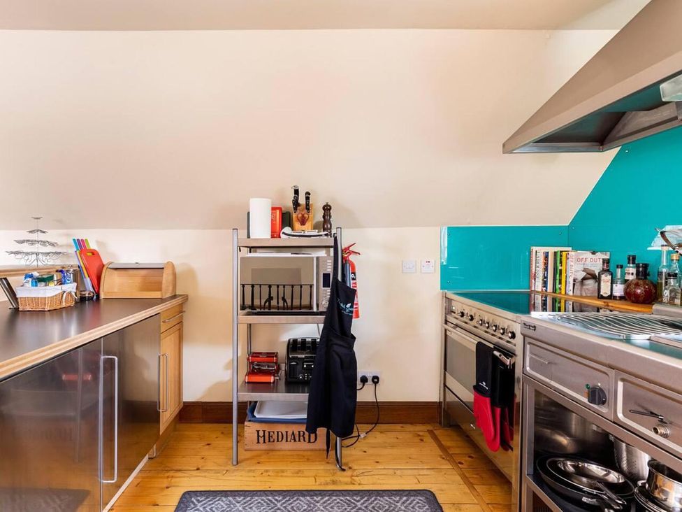 A kitchen with a stove, oven, microwave, and shelves at Luxury Duplex Sleeps 2 Hot Tub Balcony Parking, Duncrievie near Milnathort