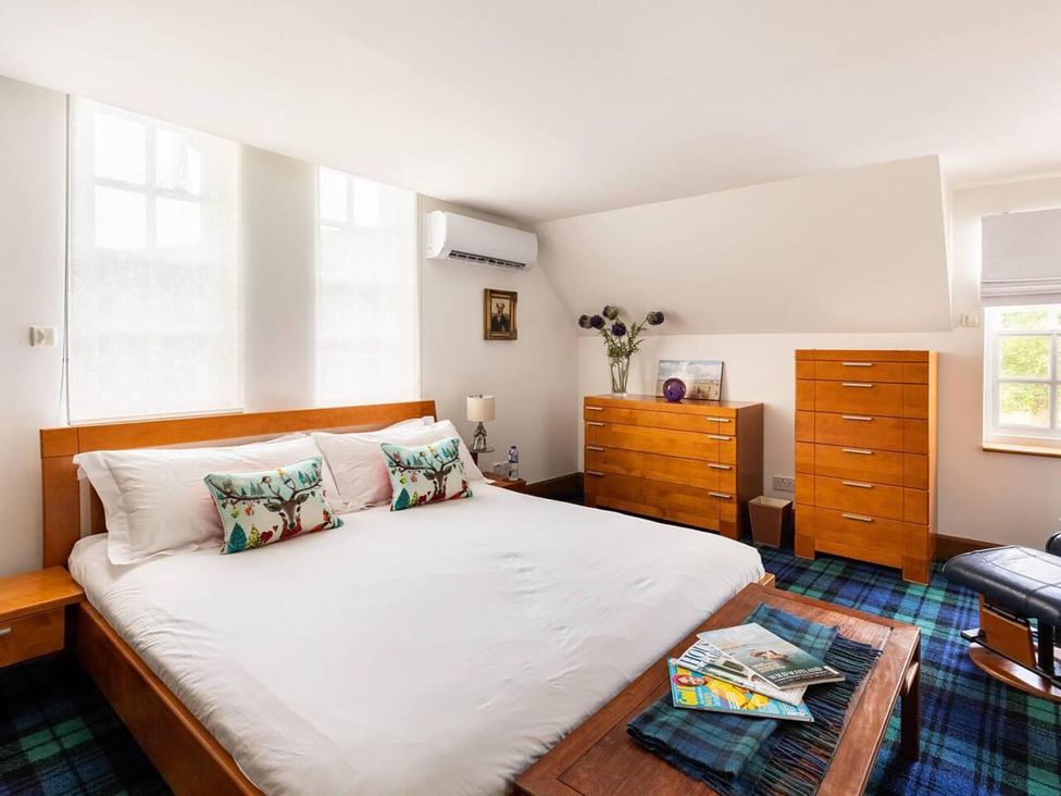 A bedroom with a double bed and a dresser at Luxury Duplex Sleeps 2 Hot Tub Balcony Parking Duncrievie near Milnathort