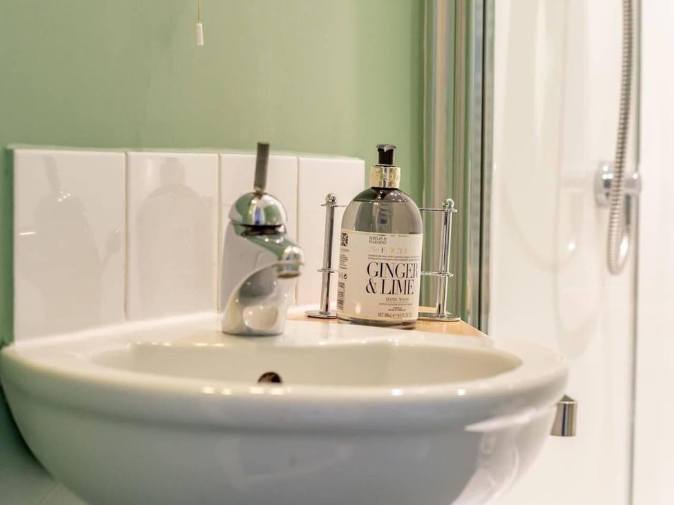 A sink with a faucet and soap dispenser in a bathroom at Luxury Duplex Sleeps 2 Hot Tub Balcony Parking Duncrievie near Milnathort