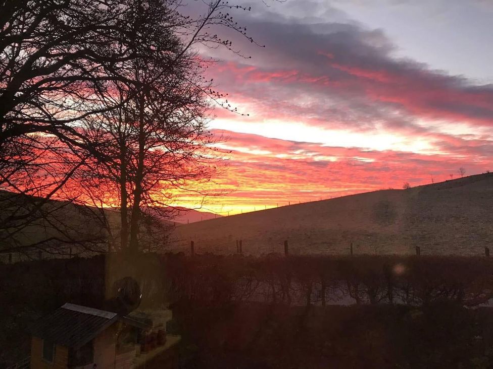 A sunset view over hills and trees at Luxury Duplex Sleeps 2 Hot Tub Balcony Parking in Duncrievie near Milnathort