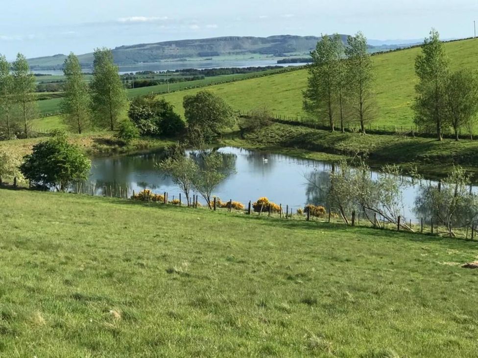 A view of a pond surrounded by grass and trees at Luxury Duplex Sleeps 2 Hot Tub Balcony Parking Duncrievie near Milnathort