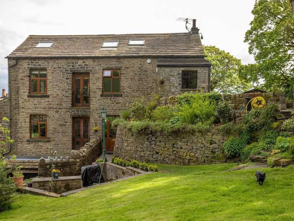 A stone house with a garden in front at OldMill 2Bed Sleeps6 PrivateGarden OptionalHotTub in Oakworth