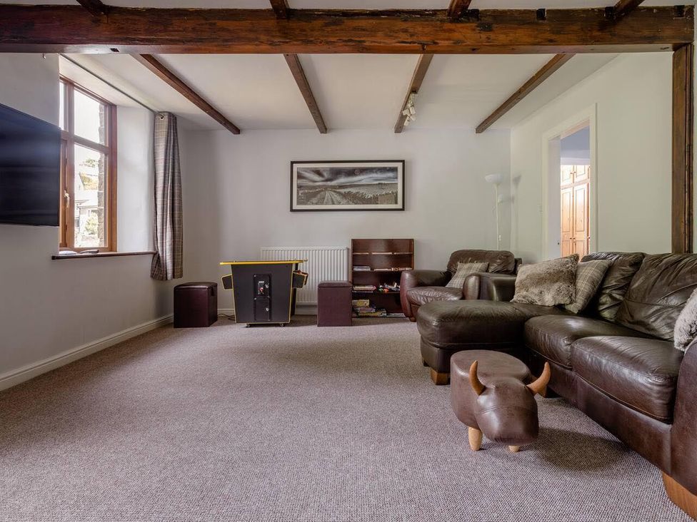 A living room with a sofa and television at OldMill 2Bed Sleeps6 PrivateGarden OptionalHotTub in Oakworth