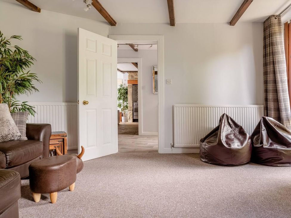A living room with a sofa and a door at OldMill 2Bed Sleeps6 PrivateGarden OptionalHotTub in Oakworth