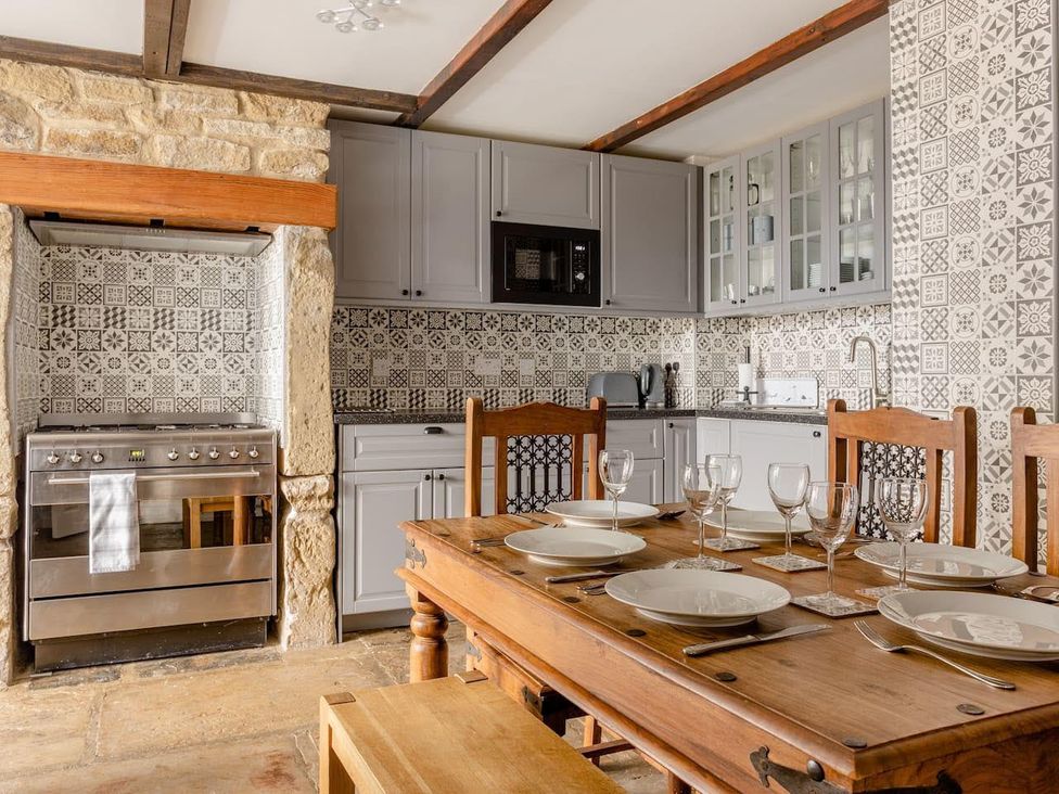 A kitchen with a dining table set at OldMill 2Bed Sleeps6 PrivateGarden OptionalHotTub in Oakworth