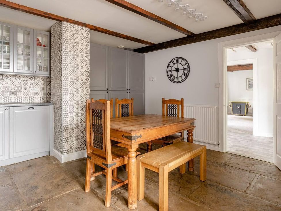 A dining room with a wooden table and chairs at OldMill 2Bed Sleeps6 PrivateGarden OptionalHotTub in Oakworth